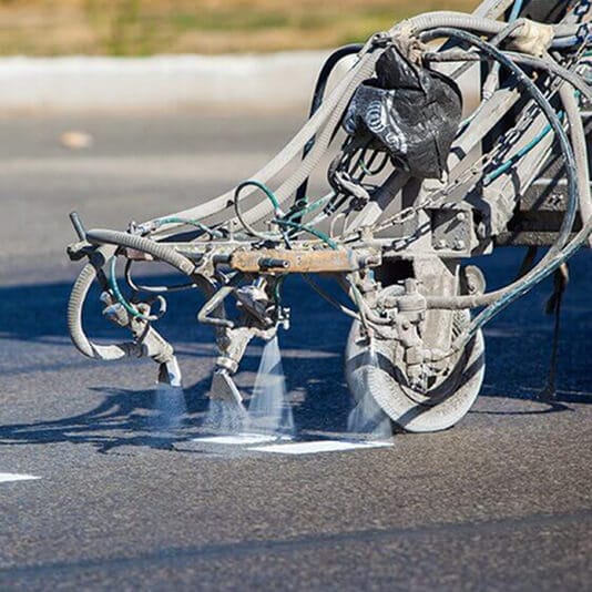 close-up of machine striping parking lot
